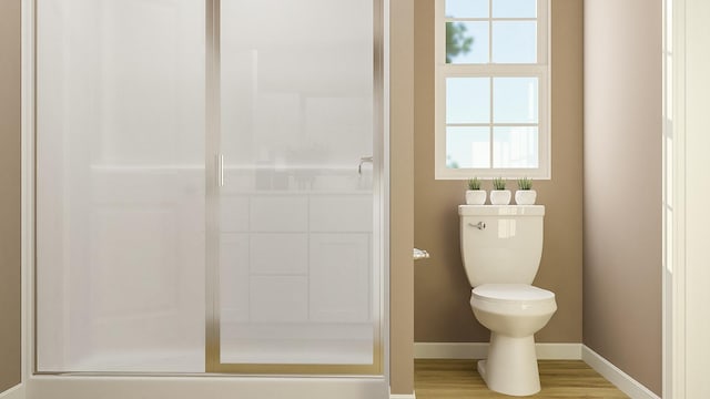 1066 Cleveland Mdws, Spartanburg, SC 29303 - bathroom featuring toilet, baseboards, a shower, and wood finished floors