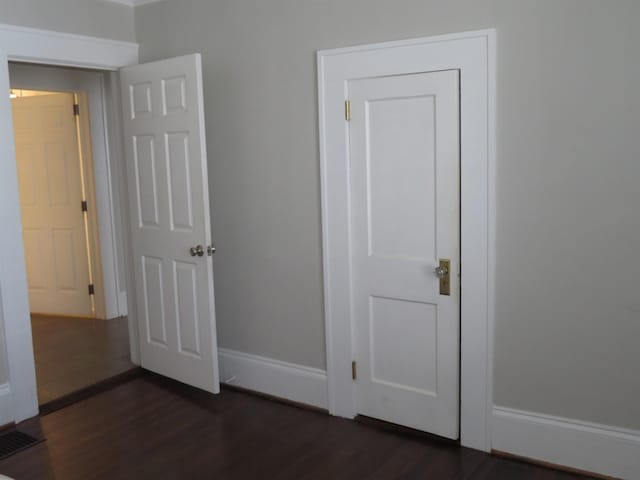525 Glendalyn, Spartanburg, SC 29302 - unfurnished bedroom featuring dark wood finished floors and baseboards