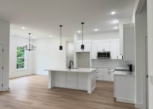 1623 Fairfield, Chesnee, SC 29323 - kitchen with stainless steel microwave, light wood-style flooring, backsplash, white cabinetry, and recessed lighting