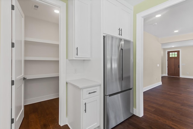 130 Market Bay, Simpsonville, SC 29681 - kitchen with stainless steel refrigerator, dark wood-style floors, white cabinetry, light countertops, and backsplash