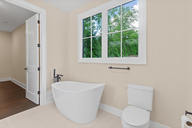 130 Market Bay, Simpsonville, SC 29681 - bathroom featuring a soaking tub, baseboards, and toilet