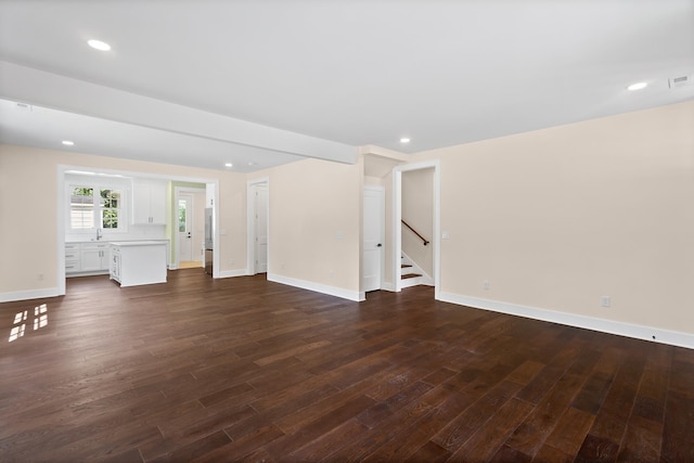 130 Market Bay, Simpsonville, SC 29681 - unfurnished living room with stairs, dark wood-style flooring, baseboards, a sink, and recessed lighting