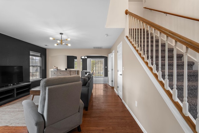 100 Maximus, Greer, SC 29651 - living area with baseboards, arched walkways, wood finished floors, a chandelier, and stairs