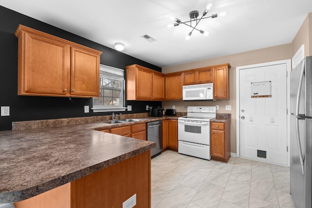 100 Maximus, Greer, SC 29651 - kitchen with appliances with stainless steel finishes, a sink, dark countertops, light marble finish floors, and brown cabinets