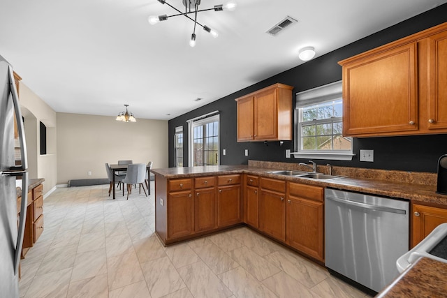 100 Maximus, Greer, SC 29651 - kitchen with a chandelier, stainless steel appliances, a sink, brown cabinetry, and dark countertops