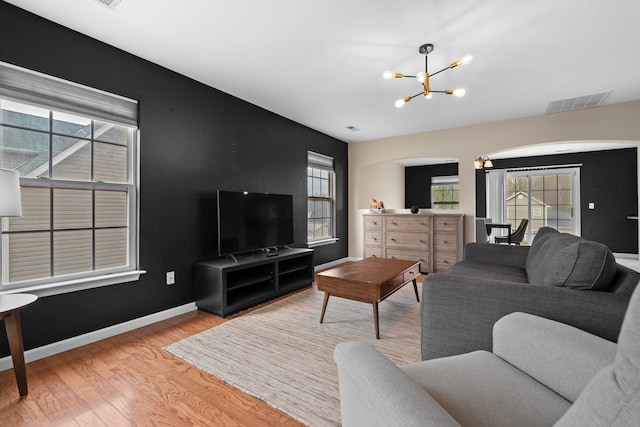 100 Maximus, Greer, SC 29651 - living area featuring a chandelier, arched walkways, wood finished floors, and baseboards