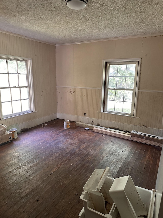 131 Furman St, Enoree, SC 29388 - unfurnished room with wood-type flooring, a textured ceiling, wooden walls, and wainscoting