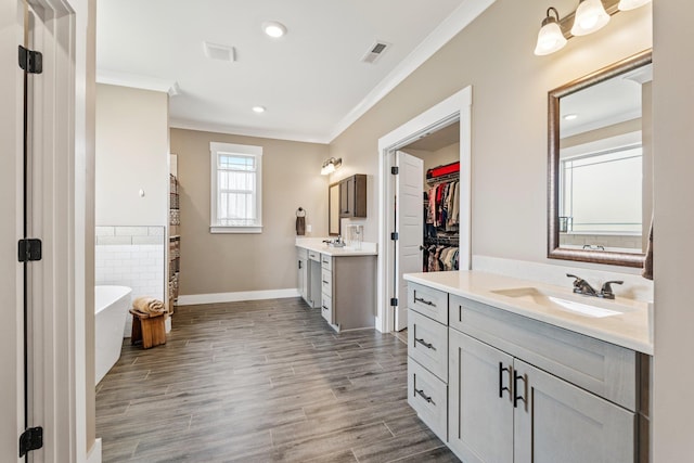 222 Blease Horton, Boiling Springs, SC 29316 - full bathroom with ornamental molding, two vanities, a freestanding tub, wood finished floors, and baseboards