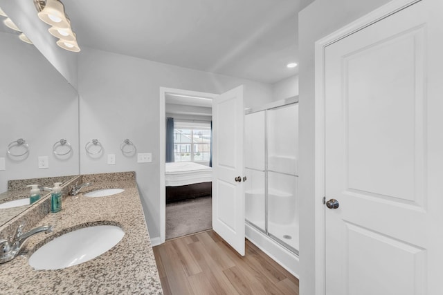 7096 Luna Mae, Boiling Springs, SC 29316 - ensuite bathroom featuring wood finished floors, a stall shower, and double vanity