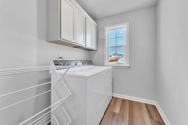 7096 Luna Mae, Boiling Springs, SC 29316 - laundry area featuring washing machine and clothes dryer, cabinet space, light wood finished floors, and baseboards