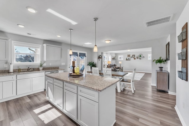 7096 Luna Mae, Boiling Springs, SC 29316 - kitchen featuring a kitchen island, hanging light fixtures, light wood finished floors, light stone countertops, and recessed lighting