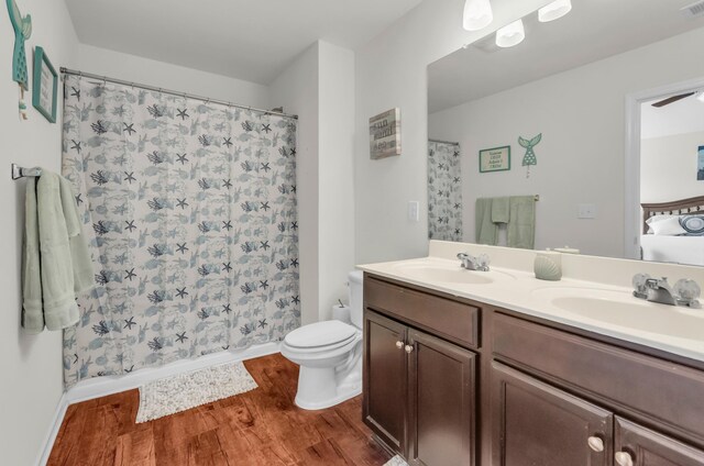 651 Willow Bank, Moore, SC 29369 - full bath featuring wood finished floors, double vanity, toilet, baseboards, and shower / bathtub combination with curtain