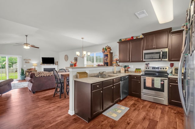 651 Willow Bank, Moore, SC 29369 - kitchen with appliances with stainless steel finishes, a peninsula, open floor plan, a chandelier, and dark brown cabinets