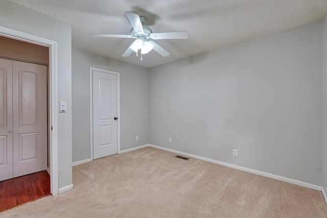 9 Powell, Inman, SC 29349 - unfurnished bedroom with light colored carpet, baseboards, a textured ceiling, and ceiling fan