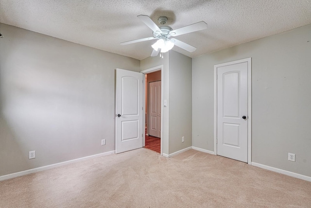 9 Powell, Inman, SC 29349 - unfurnished bedroom featuring light colored carpet, baseboards, a textured ceiling, ceiling fan, and a closet