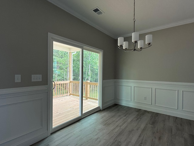 231 Patch, Spartanburg, SC 29302 - unfurnished dining area featuring a chandelier, ornamental molding, wainscoting, wood finished floors, and a decorative wall