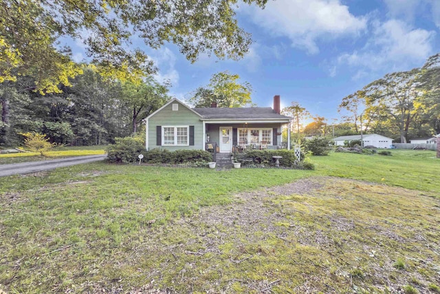 2413 Andrews, Spartanburg, SC 29302 - view of front facade featuring a porch, a chimney, and a front yard