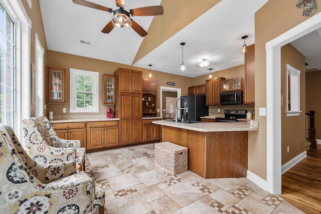2131 Brockman Mcclimon, Greer, SC 29651 - kitchen featuring black appliances, brown cabinets, light countertops, a peninsula, and ceiling fan