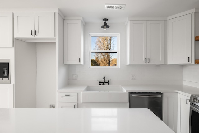 1661 Belcher, Inman, SC 29349 - kitchen featuring stainless steel appliances, tasteful backsplash, light countertops, and white cabinetry