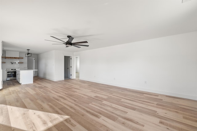 1661 Belcher, Inman, SC 29349 - unfurnished living room featuring light wood-style floors, baseboards, and a ceiling fan