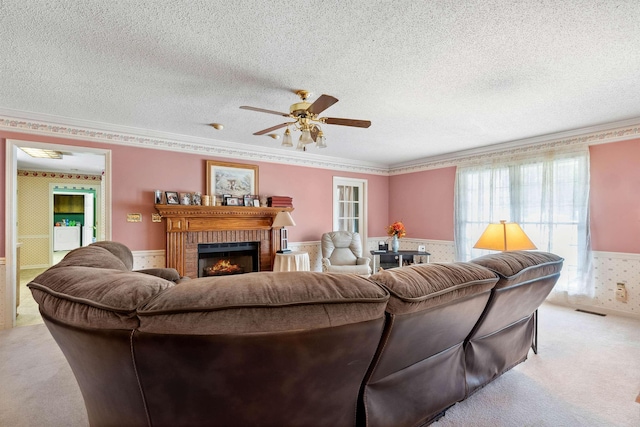 11 Midland, Taylors, SC 29687 - carpeted living room with a ceiling fan, a textured ceiling, a fireplace, a wainscoted wall, and crown molding