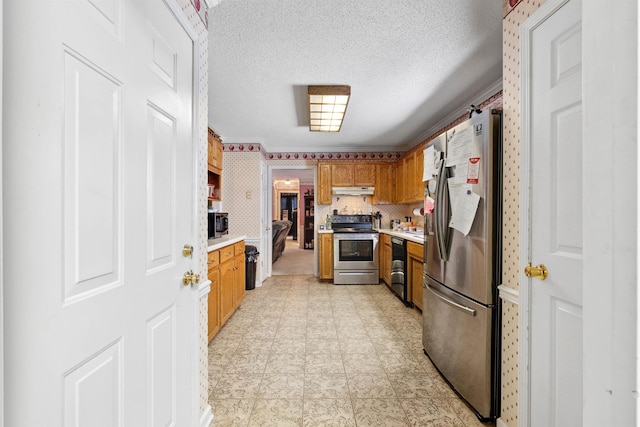 11 Midland, Taylors, SC 29687 - kitchen with appliances with stainless steel finishes, light countertops, brown cabinetry, a textured ceiling, and under cabinet range hood
