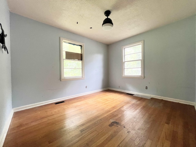 453 Lucerne, Spartanburg, SC 29302 - spare room with plenty of natural light, wood-type flooring, baseboards, and a textured ceiling