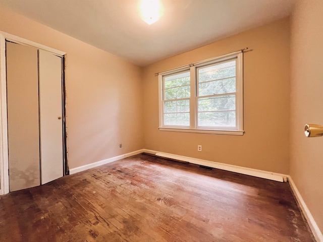 453 Lucerne, Spartanburg, SC 29302 - unfurnished bedroom featuring wood finished floors, baseboards, and a closet