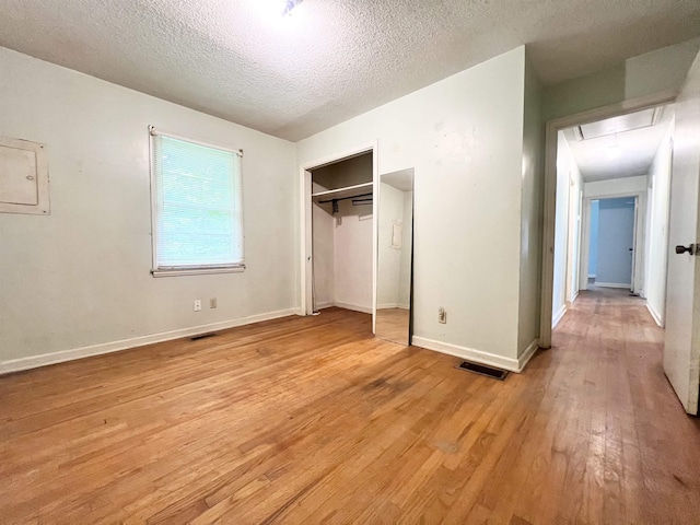 453 Lucerne, Spartanburg, SC 29302 - unfurnished bedroom featuring attic access, electric panel, light wood finished floors, a textured ceiling, and a closet