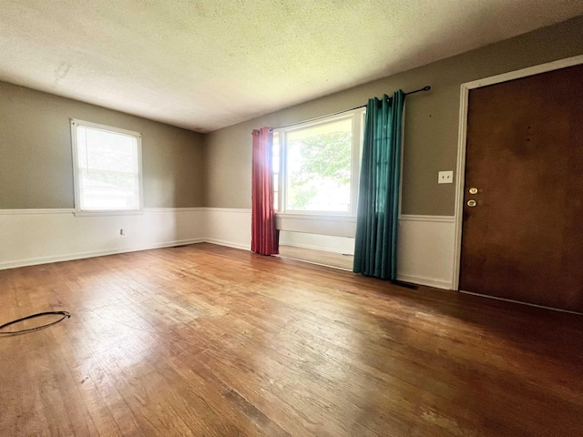 453 Lucerne, Spartanburg, SC 29302 - empty room featuring wood finished floors, healthy amount of natural light, a textured ceiling, and baseboards
