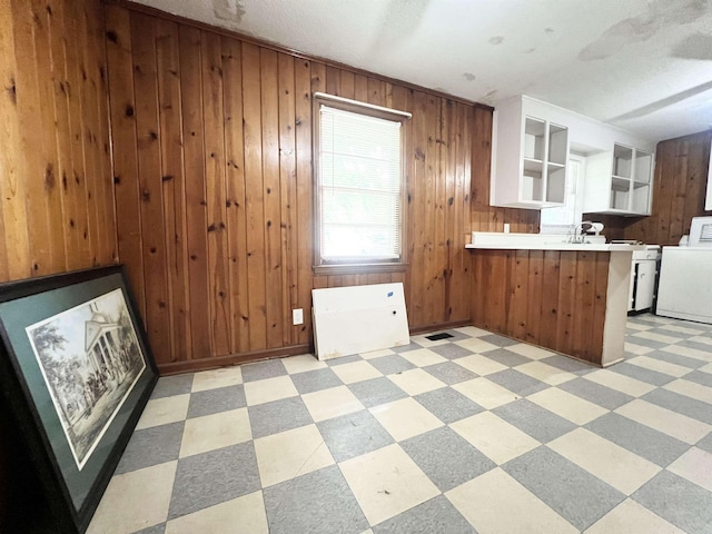 453 Lucerne, Spartanburg, SC 29302 - kitchen featuring washer / dryer, light flooring, a peninsula, wood walls, and open floor plan