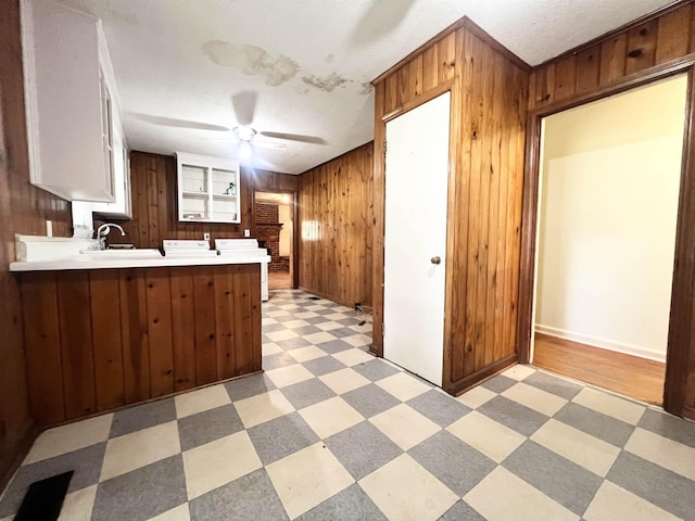 453 Lucerne, Spartanburg, SC 29302 - kitchen featuring light floors, a peninsula, wooden walls, light countertops, and a sink