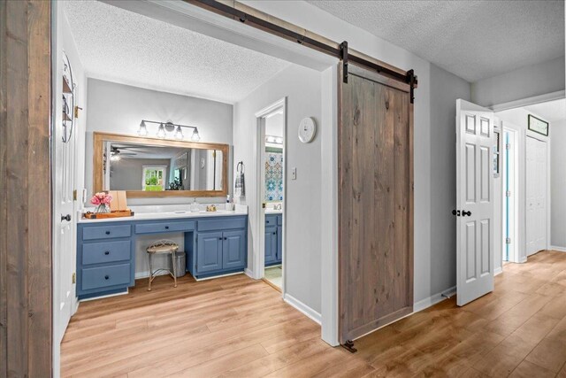 805 Laurel, Spartanburg, SC 29301 - bathroom featuring a textured ceiling, wood finished floors, vanity, and baseboards