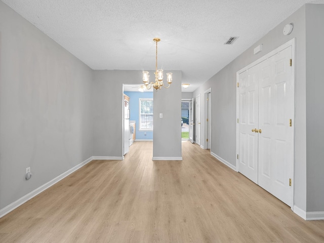 1156 Webber, Spartanburg, SC 29307 - unfurnished dining area with a chandelier, light wood finished floors, baseboards, and a textured ceiling