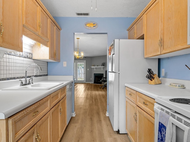 1156 Webber, Spartanburg, SC 29307 - kitchen with a sink, light wood finished floors, tasteful backsplash, white appliances, and light countertops