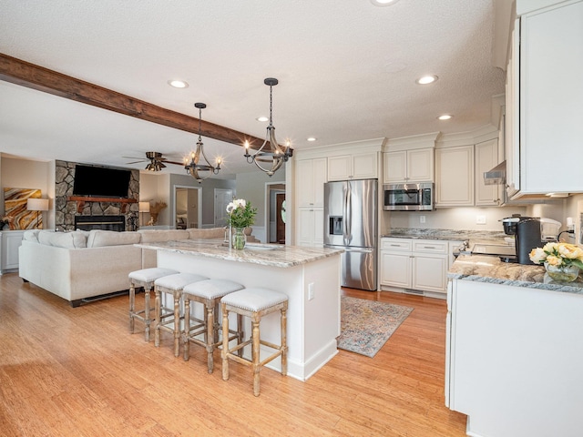 760 Three Wood, Woodruff, SC 29388 - kitchen featuring stainless steel appliances, a chandelier, light wood-style flooring, recessed lighting, and beamed ceiling