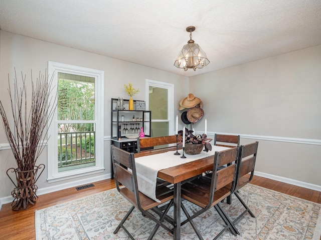 760 Three Wood, Woodruff, SC 29388 - dining area featuring a chandelier, wood finished floors, and baseboards