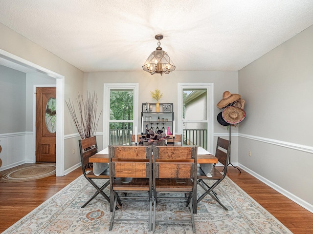 760 Three Wood, Woodruff, SC 29388 - dining area featuring a chandelier, wood finished floors, and a textured ceiling