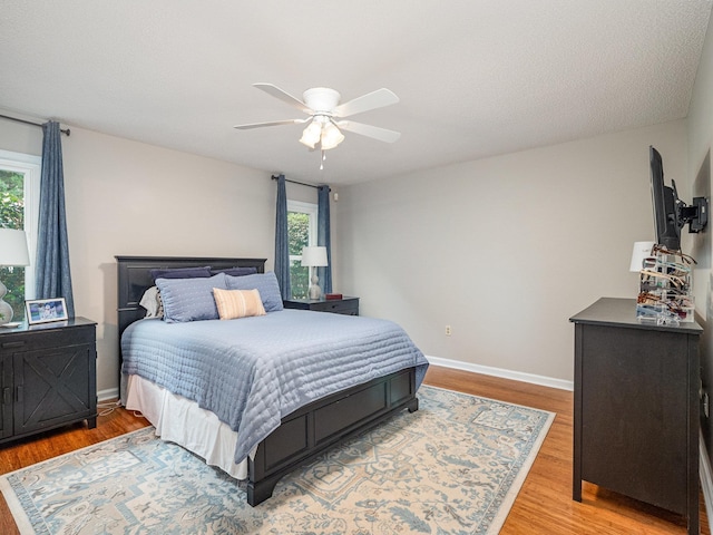 760 Three Wood, Woodruff, SC 29388 - bedroom featuring multiple windows, light wood-style flooring, baseboards, and a ceiling fan