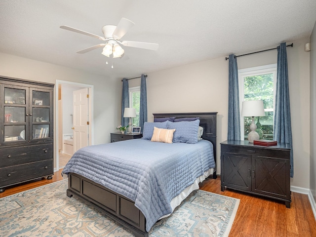 760 Three Wood, Woodruff, SC 29388 - bedroom with wood finished floors, connected bathroom, and ceiling fan