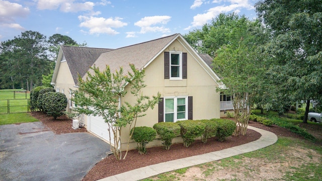 760 Three Wood, Woodruff, SC 29388 - view of side of home featuring stucco siding, driveway, a shingled roof, and a garage