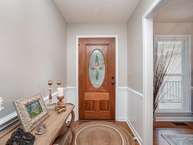 760 Three Wood, Woodruff, SC 29388 - entrance foyer with a textured ceiling, wood finished floors, and a wainscoted wall