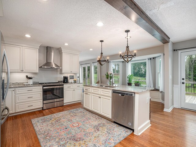 760 Three Wood, Woodruff, SC 29388 - kitchen with wall chimney exhaust hood, appliances with stainless steel finishes, a sink, a chandelier, and a textured ceiling