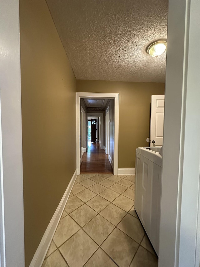 221 Mill, Gaffney, SC 29341 - corridor with washer / clothes dryer, a textured ceiling, light tile patterned floors, and baseboards