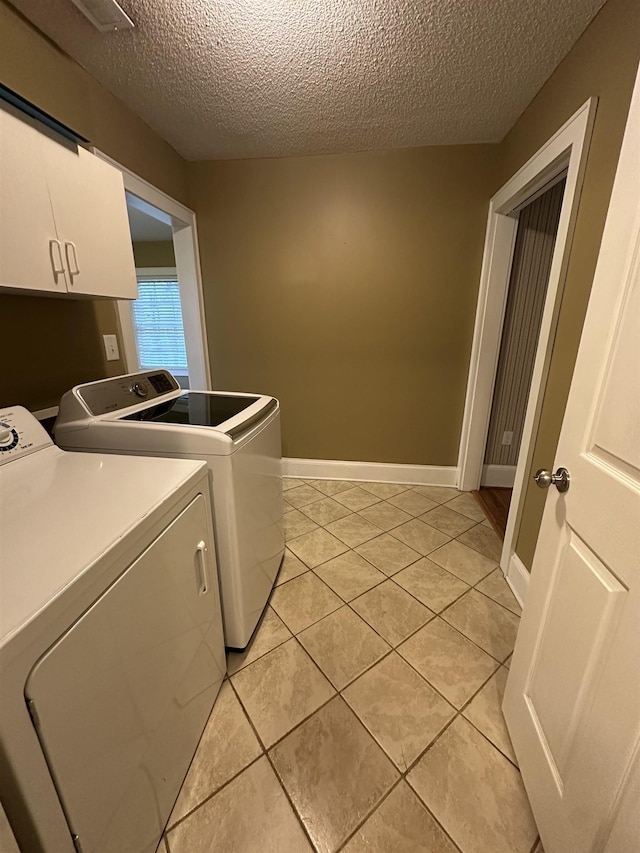 221 Mill, Gaffney, SC 29341 - washroom with independent washer and dryer, cabinet space, a textured ceiling, light tile patterned floors, and baseboards