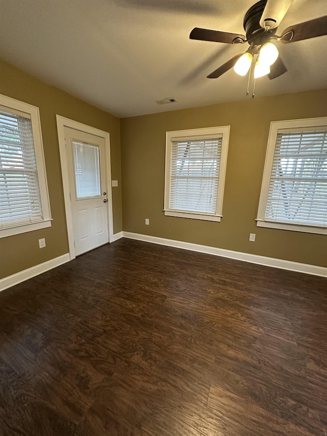 221 Mill, Gaffney, SC 29341 - spare room featuring healthy amount of natural light, dark wood-type flooring, and baseboards
