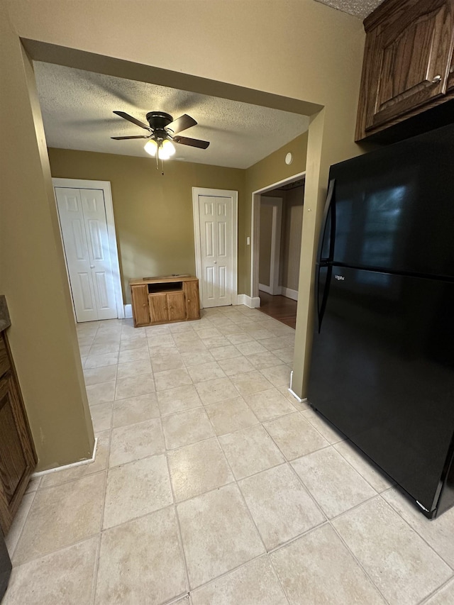 221 Mill, Gaffney, SC 29341 - kitchen featuring freestanding refrigerator, a textured ceiling, ceiling fan, light tile patterned floors, and baseboards
