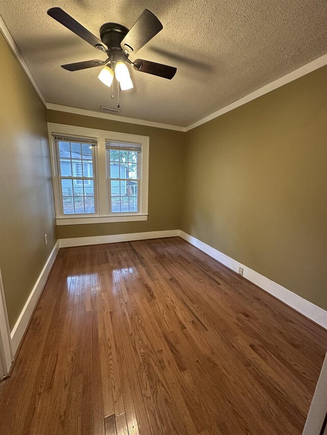 221 Mill, Gaffney, SC 29341 - empty room featuring a textured ceiling, crown molding, dark wood-style flooring, ceiling fan, and baseboards
