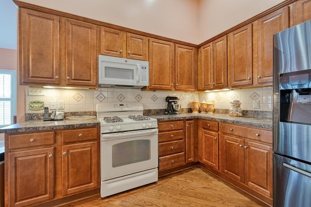 427 Listrac, Moore, SC 29369 - kitchen featuring white appliances, dark countertops, and brown cabinetry