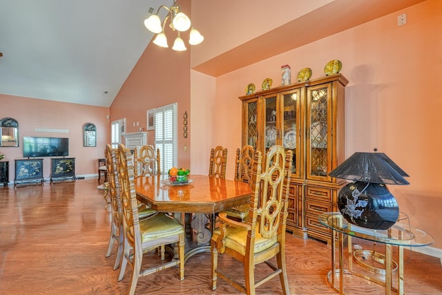 427 Listrac, Moore, SC 29369 - dining space with high vaulted ceiling, wood finished floors, a chandelier, and baseboards